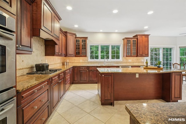 71 Louville Ave, Park Ridge, NJ 07656 - kitchen featuring stainless steel appliances, a sink, light stone counters, a kitchen island, and recessed lighting