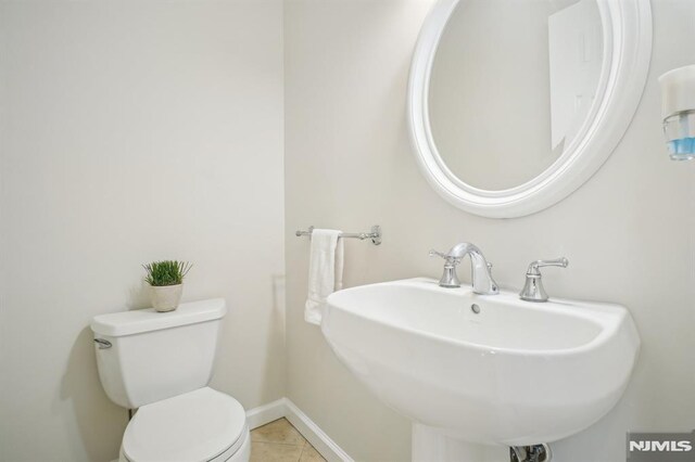71 Louville Ave, Park Ridge, NJ 07656 - bathroom featuring toilet, tile patterned floors, a sink, and baseboards