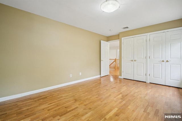 71 Louville Ave, Park Ridge, NJ 07656 - unfurnished bedroom with multiple closets, light wood-type flooring, and baseboards