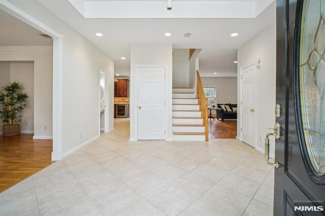 71 Louville Ave, Park Ridge, NJ 07656 - foyer entrance with light tile patterned floors, stairway, recessed lighting, baseboards, and wine cooler