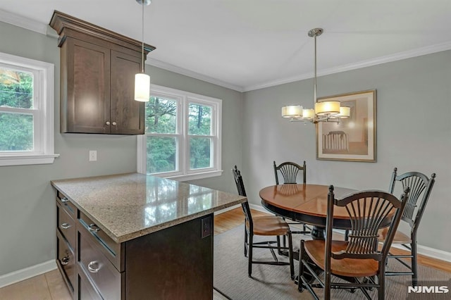 151 Palisade Ave Unit C8, Englewood, NJ 07631 - kitchen featuring dark brown cabinetry, baseboards, ornamental molding, and light stone counters