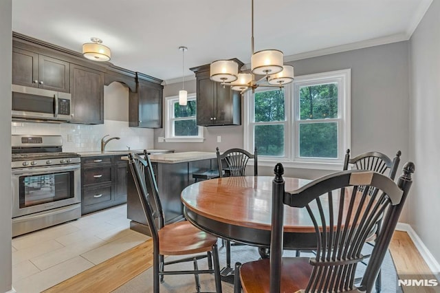 151 Palisade Ave Unit C8, Englewood, NJ 07631 - dining room featuring ornamental molding, a chandelier, light wood-style flooring, and baseboards
