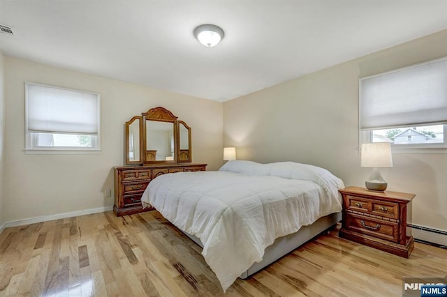 830 Pennsylvania Ave, Lyndhurst, NJ 07071 - bedroom with a baseboard radiator, light wood-style floors, and baseboards