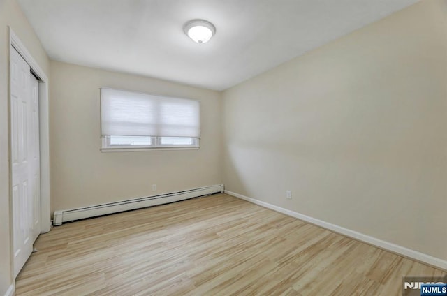 830 Pennsylvania Ave, Lyndhurst, NJ 07071 - unfurnished bedroom with a baseboard radiator, wood finished floors, and baseboards