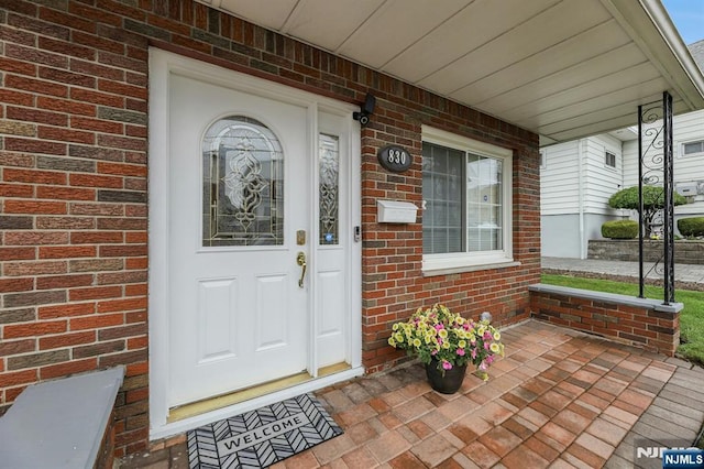 830 Pennsylvania Ave, Lyndhurst, NJ 07071 - doorway to property featuring a porch and brick siding