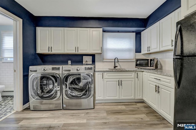 830 Pennsylvania Ave, Lyndhurst, NJ 07071 - laundry room featuring healthy amount of natural light, baseboard heating, washer and dryer, and light wood-type flooring