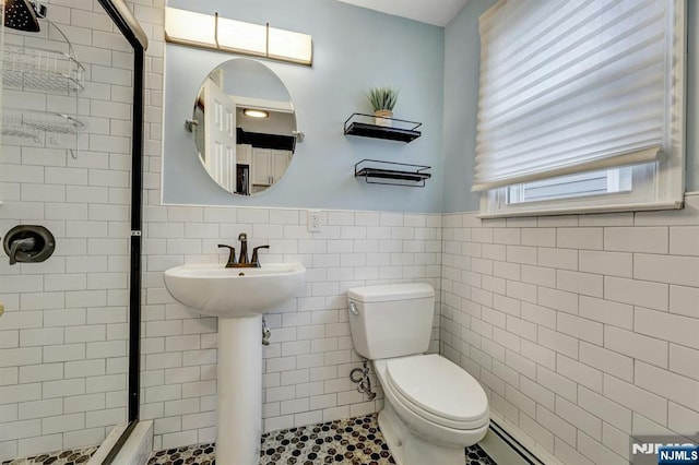 830 Pennsylvania Ave, Lyndhurst, NJ 07071 - bathroom with tile walls, toilet, a shower stall, wainscoting, and a baseboard heating unit