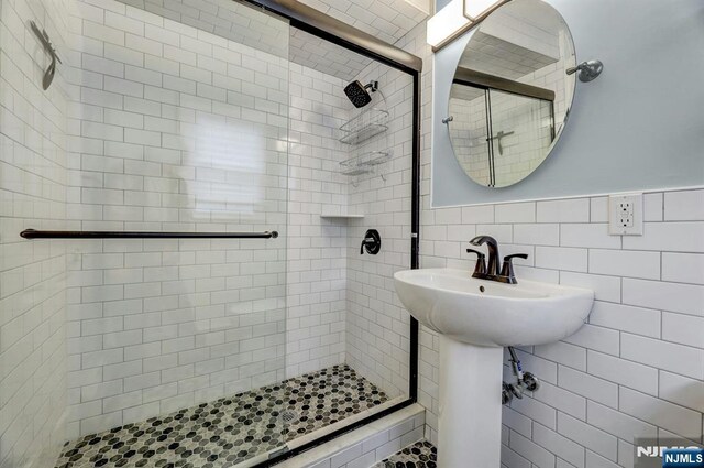 830 Pennsylvania Ave, Lyndhurst, NJ 07071 - full bathroom featuring a shower stall, tile walls, and wainscoting