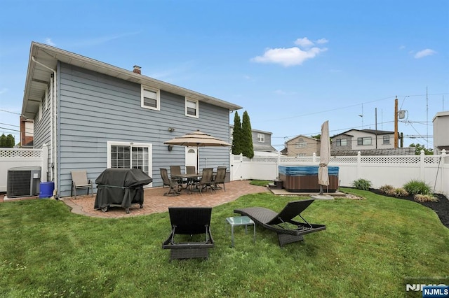 830 Pennsylvania Ave, Lyndhurst, NJ 07071 - back of property featuring a hot tub, central AC, a patio area, and a chimney