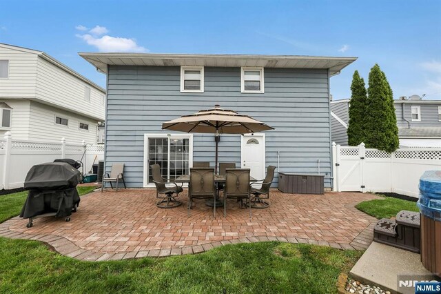 830 Pennsylvania Ave, Lyndhurst, NJ 07071 - back of property with a patio, a fenced backyard, and a gate