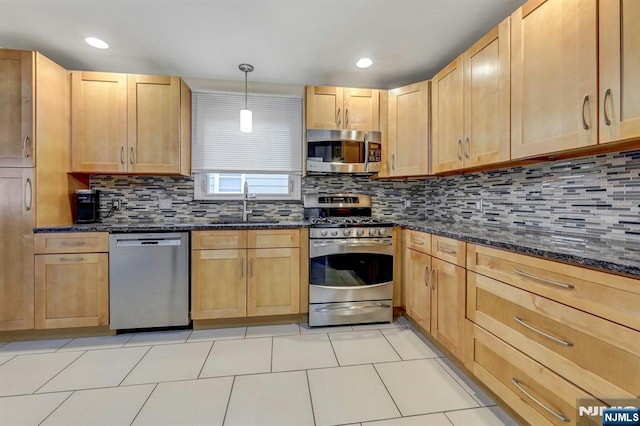 830 Pennsylvania Ave, Lyndhurst, NJ 07071 - kitchen with stainless steel appliances, a sink, backsplash, light brown cabinets, and dark stone countertops