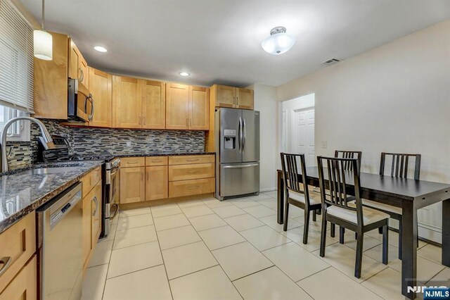 830 Pennsylvania Ave, Lyndhurst, NJ 07071 - kitchen featuring stainless steel appliances, a sink, tasteful backsplash, dark stone counters, and recessed lighting