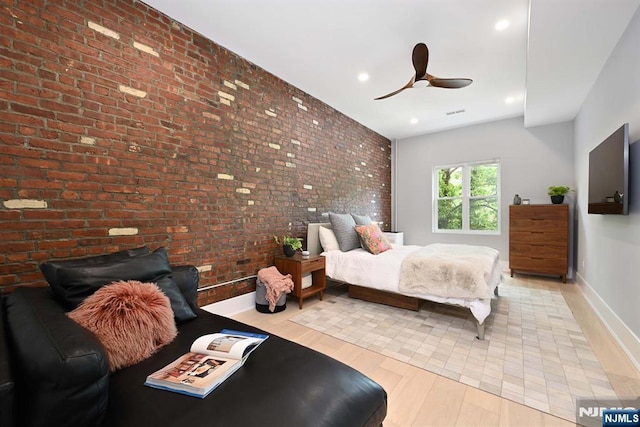 500 Hudson St Unit 2A, Hoboken, NJ 07030 - bedroom with light wood-type flooring, baseboards, ceiling fan, brick wall, and recessed lighting