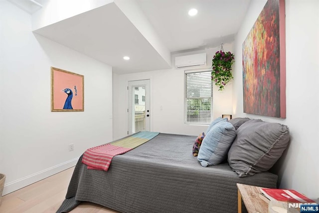606 1st St Unit 1, Hoboken, NJ 07030 - bedroom with a wall unit AC, light wood finished floors, recessed lighting, and baseboards