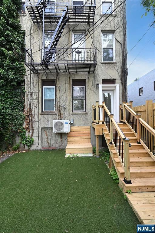 606 1st St Unit 1, Hoboken, NJ 07030 - view of front facade featuring a balcony, a cooling unit, and stucco siding