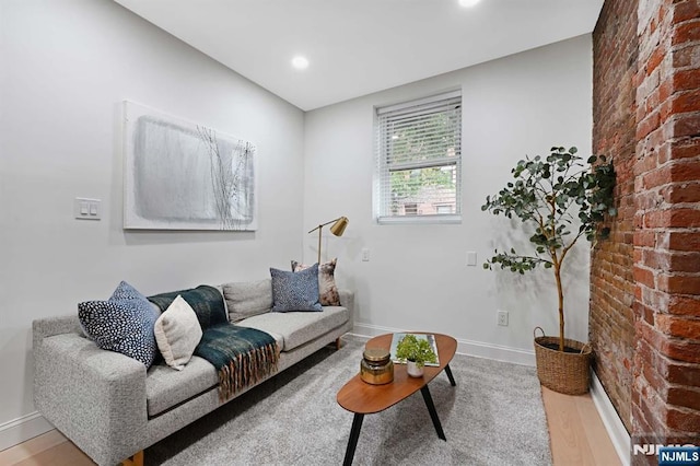 606 1st St Unit 1, Hoboken, NJ 07030 - living area featuring brick wall, wood finished floors, baseboards, and recessed lighting