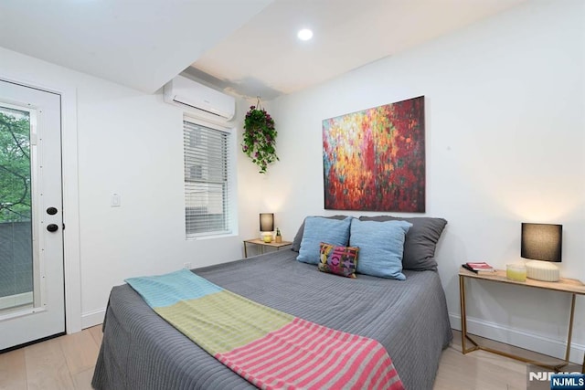 606 1st St Unit 1, Hoboken, NJ 07030 - bedroom featuring a wall mounted air conditioner, wood finished floors, recessed lighting, and baseboards