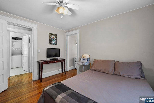 11 Harrington St, Hillsdale, NJ 07642 - bedroom featuring stacked washer / drying machine, wood finished floors, a ceiling fan, and baseboards