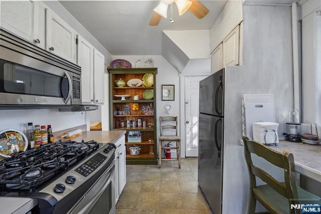 11 Harrington St, Hillsdale, NJ 07642 - kitchen with stainless steel appliances, a ceiling fan, white cabinetry, light countertops, and stone finish flooring