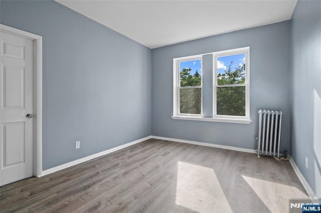 143 Duncan Ave Unit 8/108, Jersey City, NJ 07306 - spare room featuring radiator heating unit, wood finished floors, and baseboards