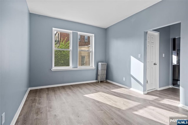 143 Duncan Ave Unit 8/108, Jersey City, NJ 07306 - empty room featuring radiator heating unit, wood finished floors, and baseboards