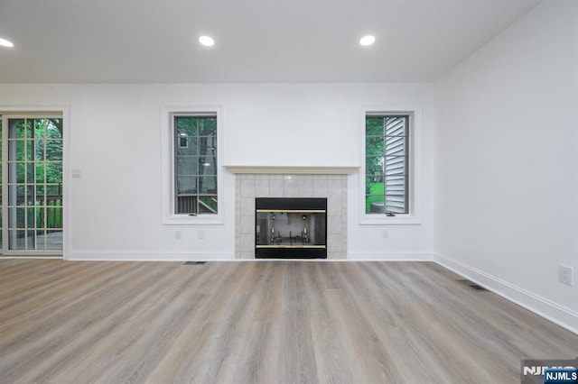 3 Bradshaw Ct Unit 509, Hillsdale, NJ 07642 - unfurnished living room with wood finished floors, baseboards, a tiled fireplace, and recessed lighting