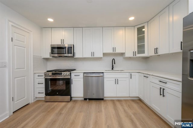 3 Bradshaw Ct Unit 509, Hillsdale, NJ 07642 - kitchen with stainless steel appliances, a sink, recessed lighting, white cabinetry, and light wood finished floors