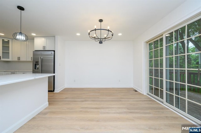 3 Bradshaw Ct Unit 509, Hillsdale, NJ 07642 - unfurnished dining area with a chandelier, recessed lighting, baseboards, and light wood-type flooring