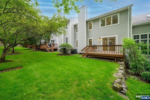 3 Bradshaw Ct Unit 509, Hillsdale, NJ 07642 - back of property featuring a deck, a lawn, central AC, and a chimney