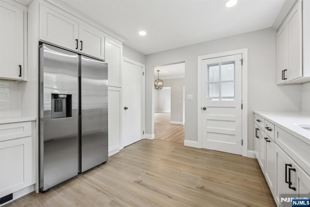 444 Black Oak Ridge Rd, Wayne, NJ 07470 - kitchen featuring stainless steel fridge with ice dispenser, light countertops, white cabinets, a chandelier, and recessed lighting