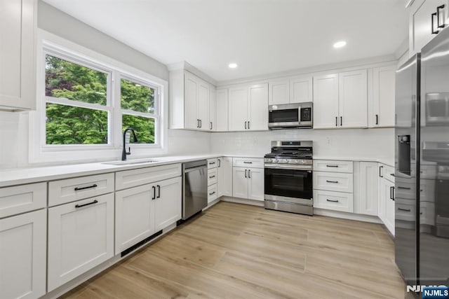 444 Black Oak Ridge Rd, Wayne, NJ 07470 - kitchen with appliances with stainless steel finishes, a sink, healthy amount of natural light, white cabinets, and recessed lighting