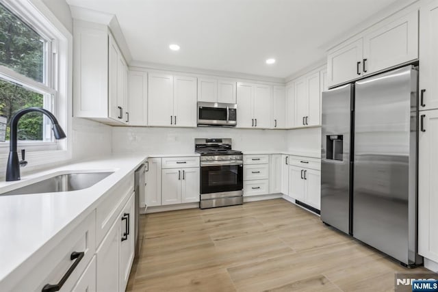 444 Black Oak Ridge Rd, Wayne, NJ 07470 - kitchen featuring stainless steel appliances, a sink, white cabinetry, recessed lighting, and light countertops