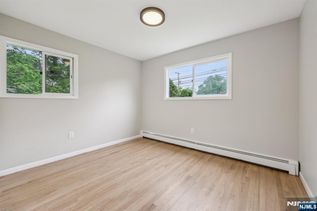 444 Black Oak Ridge Rd, Wayne, NJ 07470 - empty room featuring baseboard heating, plenty of natural light, wood finished floors, and baseboards