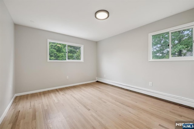 444 Black Oak Ridge Rd, Wayne, NJ 07470 - empty room with a baseboard heating unit, wood finished floors, and baseboards