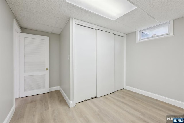 444 Black Oak Ridge Rd, Wayne, NJ 07470 - unfurnished bedroom with a paneled ceiling, wood finished floors, a closet, and baseboards