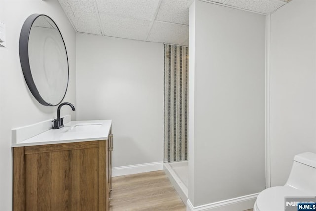 444 Black Oak Ridge Rd, Wayne, NJ 07470 - bathroom with a drop ceiling, vanity, toilet, wood finished floors, and a stall shower