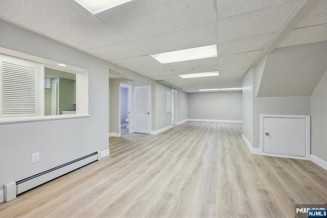 444 Black Oak Ridge Rd, Wayne, NJ 07470 - spare room with a paneled ceiling, baseboard heating, wood finished floors, and baseboards