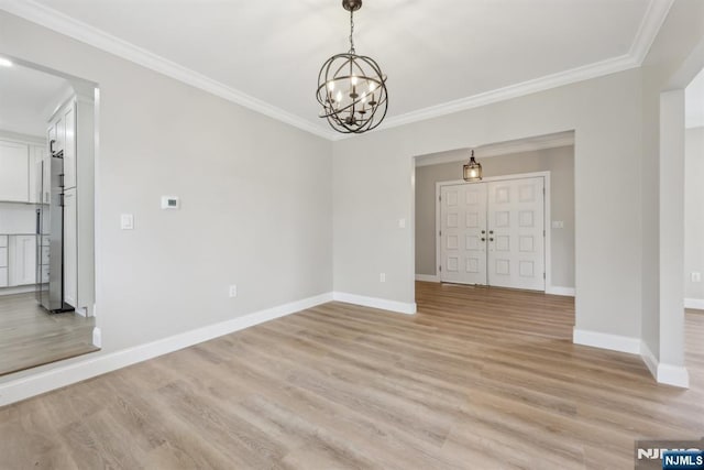 444 Black Oak Ridge Rd, Wayne, NJ 07470 - spare room featuring ornamental molding, a chandelier, light wood-style flooring, and baseboards