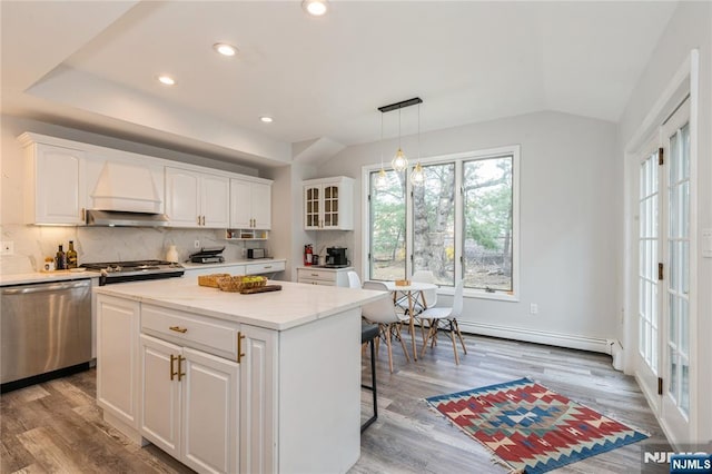 62 Valley Rd, Glen Rock, NJ 07452 - kitchen featuring stainless steel appliances, baseboard heating, white cabinets, tasteful backsplash, and wood finished floors