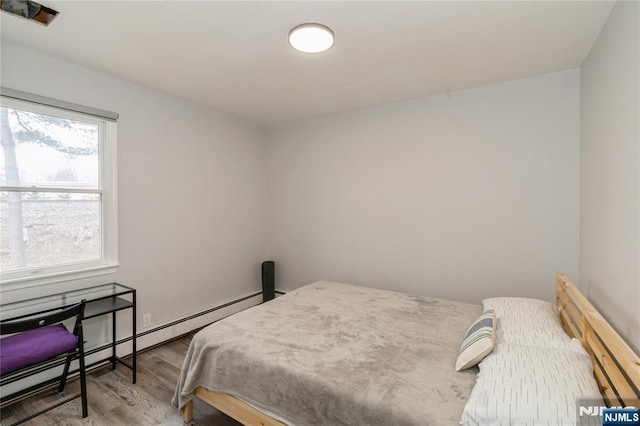 62 Valley Rd, Glen Rock, NJ 07452 - bedroom with a baseboard heating unit and wood finished floors