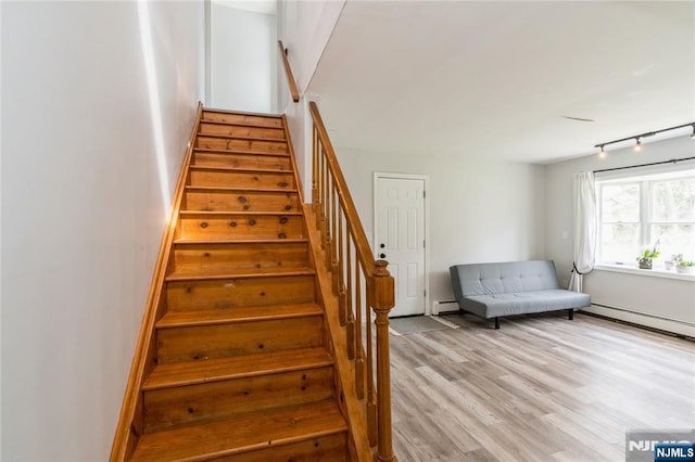 62 Valley Rd, Glen Rock, NJ 07452 - staircase with baseboard heating, wood finished floors, and baseboards