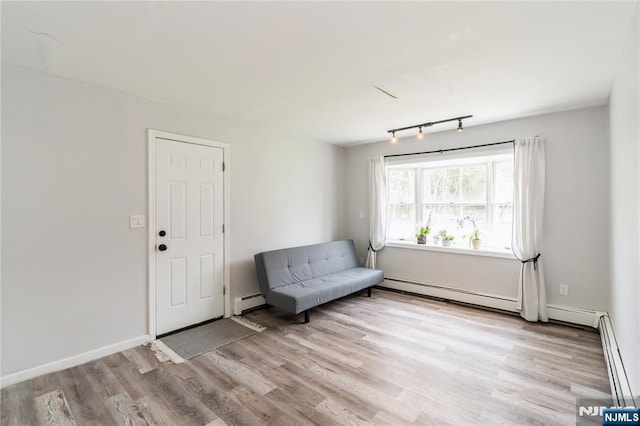 62 Valley Rd, Glen Rock, NJ 07452 - living area with light wood finished floors, a baseboard heating unit, baseboard heating, and baseboards