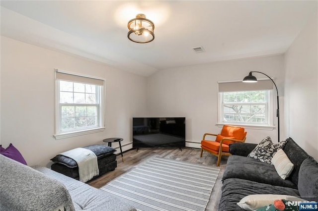 62 Valley Rd, Glen Rock, NJ 07452 - living area featuring a baseboard heating unit, wood finished floors, and vaulted ceiling