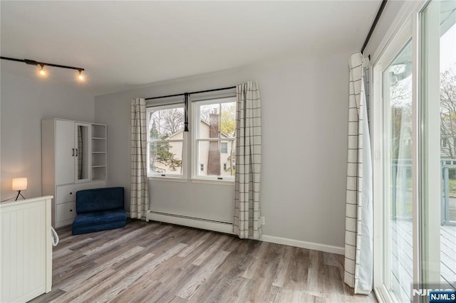 62 Valley Rd, Glen Rock, NJ 07452 - unfurnished room featuring a baseboard radiator, light wood-style floors, and track lighting