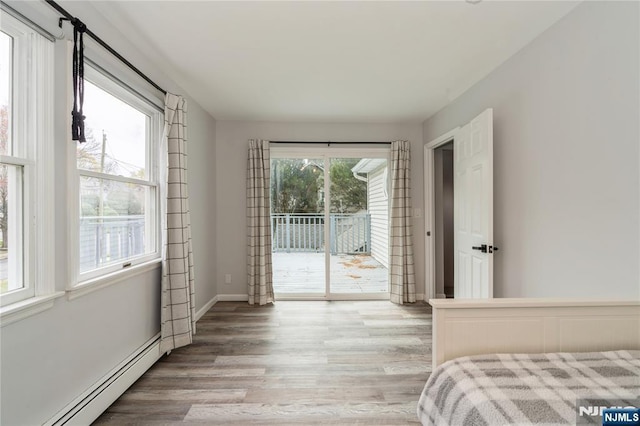 62 Valley Rd, Glen Rock, NJ 07452 - bedroom with baseboard heating, access to exterior, light wood-style floors, and baseboards