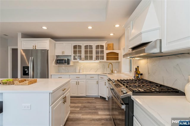 62 Valley Rd, Glen Rock, NJ 07452 - kitchen with appliances with stainless steel finishes, a sink, recessed lighting, white cabinetry, and wood finished floors