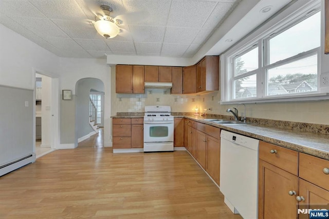 128 Prospect, Midland Park, NJ 07432 - kitchen featuring white appliances, under cabinet range hood, arched walkways, a sink, and light wood finished floors