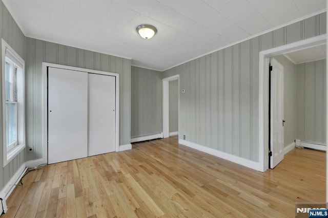 128 Prospect, Midland Park, NJ 07432 - unfurnished bedroom with ornamental molding, light wood finished floors, baseboard heating, a closet, and a baseboard heating unit