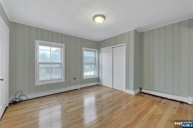 128 Prospect, Midland Park, NJ 07432 - unfurnished bedroom with ornamental molding, baseboard heating, hardwood / wood-style floors, and a closet
