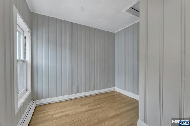 128 Prospect, Midland Park, NJ 07432 - empty room with light wood finished floors, baseboards, ornamental molding, and a baseboard heating unit